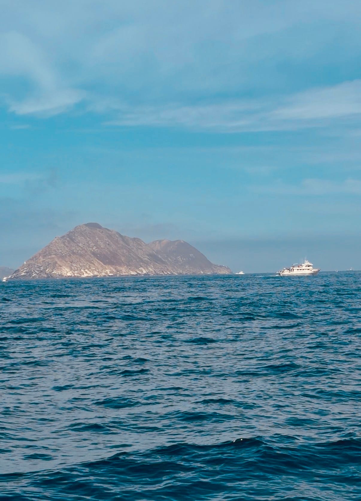 Yellowtail fishing at the Coronado Islands — sport fishing boat with rocky islands in background